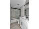 Modern bathroom featuring a shower with sliding doors, a single vanity, and modern fixtures at 3696 Se 139Th Ln, Summerfield, FL 34491