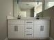 Contemporary bathroom vanity with double sinks, white cabinets and matte black hardware at 3696 Se 139Th Ln, Summerfield, FL 34491
