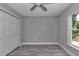 A bedroom with gray walls and wood-look floors features a window and a closet with white doors at 3696 Se 139Th Ln, Summerfield, FL 34491