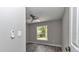 Bright bedroom features a modern ceiling fan, new window, and stylish gray wood-look floors at 3696 Se 139Th Ln, Summerfield, FL 34491