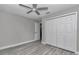 A bedroom features gray walls and wood-look floors plus a closet with a four-panel white door at 3696 Se 139Th Ln, Summerfield, FL 34491