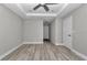 Spacious bedroom featuring tray ceiling, fan, recessed lighting and wood-look flooring at 3696 Se 139Th Ln, Summerfield, FL 34491