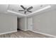 Bedroom with tray ceiling, fan, recessed lighting and wood-look flooring at 3696 Se 139Th Ln, Summerfield, FL 34491