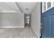 Bright entryway with attractive wood-look floors, neutral walls, and a view extending through the home to the backyard at 3696 Se 139Th Ln, Summerfield, FL 34491