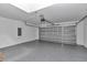 Spacious two-car garage with epoxy flooring and a modern garage door opener at 3696 Se 139Th Ln, Summerfield, FL 34491