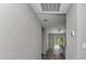 Hallway view of the open concept kitchen and living area with modern gray walls and flooring at 3696 Se 139Th Ln, Summerfield, FL 34491