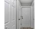 Hallway view featuring white doors and trim, creating a clean and modern aesthetic at 3696 Se 139Th Ln, Summerfield, FL 34491