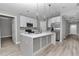 Kitchen with a large island, pendant lighting, white cabinets, and stainless steel appliances at 3696 Se 139Th Ln, Summerfield, FL 34491