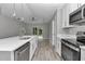 Bright kitchen with stainless steel appliances, white cabinets and quartz countertops at 3696 Se 139Th Ln, Summerfield, FL 34491