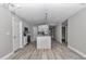 Modern kitchen featuring stainless steel appliances, island, and light wood-look flooring at 3696 Se 139Th Ln, Summerfield, FL 34491