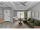 Inviting living room featuring a modern ceiling fan, recessed lighting, and stylish contemporary furnishings at 3696 Se 139Th Ln, Summerfield, FL 34491