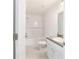 Bathroom boasts a shower-tub combo, white tile, and modern fixtures at 37 Teak Run, Ocala, FL 34472