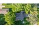 Aerial view of the home showcases lush landscaping with mature trees and a well-maintained roof at 4609 Ne 7Th St, Ocala, FL 34470