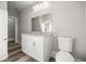 Bathroom featuring modern vanity, new lighting, and toilet at 4609 Ne 7Th St, Ocala, FL 34470
