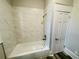 This bathroom features a tub with white marble tile and a shower head at 4609 Ne 7Th St, Ocala, FL 34470