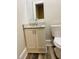 Bathroom vanity with granite countertop, modern faucet, mirror and white cabinets at 4609 Ne 7Th St, Ocala, FL 34470