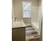 Bathroom featuring a white tub with white marble tile, and a vanity with granite countertop at 4609 Ne 7Th St, Ocala, FL 34470