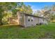 Exterior view of home with tan siding, green lawn, and landscaping at 4609 Ne 7Th St, Ocala, FL 34470