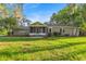 Charming single-story home with mature trees, screened porch, and well-maintained lawn at 4609 Ne 7Th St, Ocala, FL 34470