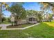 Beautiful home featuring lush landscaping, brick walkway, and a cozy screened front porch at 4609 Ne 7Th St, Ocala, FL 34470