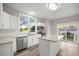 Bright kitchen with white cabinets, granite countertops, island, and stainless steel appliances at 4609 Ne 7Th St, Ocala, FL 34470