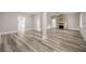 Open-concept living room with stylish flooring, fireplace, and seamless flow throughout at 4609 Ne 7Th St, Ocala, FL 34470