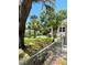 Side yard with chain-link fence, mature trees, and lush lawn, creating a private space at 4609 Ne 7Th St, Ocala, FL 34470