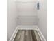 Storage area with wood-look flooring and two wire shelves at 4609 Ne 7Th St, Ocala, FL 34470