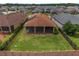 Aerial view of the backyard with privacy fence, screened-in lanai, and solar panels at 5587 Nw 40Th Pl, Ocala, FL 34482