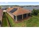 Aerial view of a home's backyard featuring solar panels, screened lanai and nice fence at 5587 Nw 40Th Pl, Ocala, FL 34482