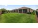 Large backyard area with green lawn and a screened lanai, perfect for outdoor living at 5587 Nw 40Th Pl, Ocala, FL 34482