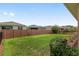 Well-manicured backyard featuring a privacy fence and lush green grass at 5587 Nw 40Th Pl, Ocala, FL 34482