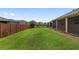 Spacious backyard showcasing the lawn and secure fencing around the property at 5587 Nw 40Th Pl, Ocala, FL 34482