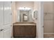 Bathroom vanity with granite countertop, vanity mirror, and walk-in closet at 5587 Nw 40Th Pl, Ocala, FL 34482