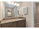Bathroom featuring granite vanity with storage and large vanity mirror at 5587 Nw 40Th Pl, Ocala, FL 34482