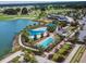 Aerial view of the community pool and amenity center with lakeside golf course views at 5587 Nw 40Th Pl, Ocala, FL 34482