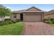 Charming single-Gathering home boasting a brick driveway and a two-car garage at 5587 Nw 40Th Pl, Ocala, FL 34482