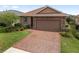 Charming single-Gathering home boasting a brick driveway and a two-car garage at 5587 Nw 40Th Pl, Ocala, FL 34482