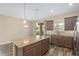 Bright kitchen boasts stainless appliances, stylish cabinets and countertops, with wood look tile flooring at 5587 Nw 40Th Pl, Ocala, FL 34482