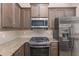 Close up on a kitchen with granite countertops, stainless steel appliances, and modern fixtures at 5587 Nw 40Th Pl, Ocala, FL 34482
