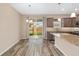 Kitchen and dining area overlooking the backyard, equipped with island, cabinetry and stainless steel appliances at 5587 Nw 40Th Pl, Ocala, FL 34482