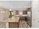 Spacious kitchen featuring wood look tile flooring, a large granite island, and stainless steel appliances at 5587 Nw 40Th Pl, Ocala, FL 34482
