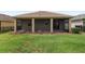 A covered and screened lanai overlooking the lawn and well maintained landscaping at 5587 Nw 40Th Pl, Ocala, FL 34482