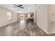 Expansive living room featuring stylish tile flooring and natural light from surrounding windows and sliding glass door at 5587 Nw 40Th Pl, Ocala, FL 34482