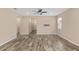 Spacious and neutral living room with a ceiling fan, leading to other parts of the house at 5587 Nw 40Th Pl, Ocala, FL 34482
