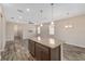 Open-concept living room features a large island, wood look tile flooring, and recessed lighting at 5587 Nw 40Th Pl, Ocala, FL 34482
