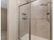 Tiled shower with a glass door and built-in storage shelves at 5587 Nw 40Th Pl, Ocala, FL 34482
