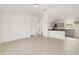 Spacious open-concept living space showcasing light tile floors and kitchen access at 6 Locust Loop Crse, Ocala, FL 34472