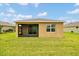 The backyard offers a screened patio with a spacious, well-maintained lawn at 6318 Sw 89Th Lane Rd, Ocala, FL 34476