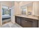 Bathroom with a granite countertop double vanity adjacent to the bedroom at 6318 Sw 89Th Lane Rd, Ocala, FL 34476